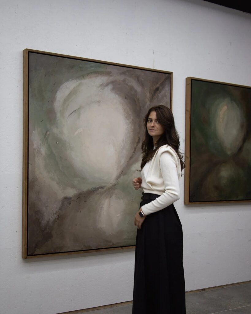 Raluca Luchian beside two of her paintings in her Knokke-Heist studio