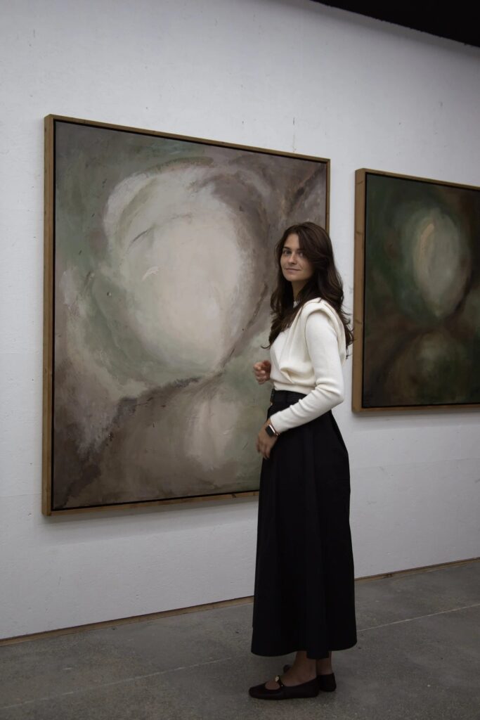 Raluca Luchian beside two of her paintings in her Knokke-Heist studio